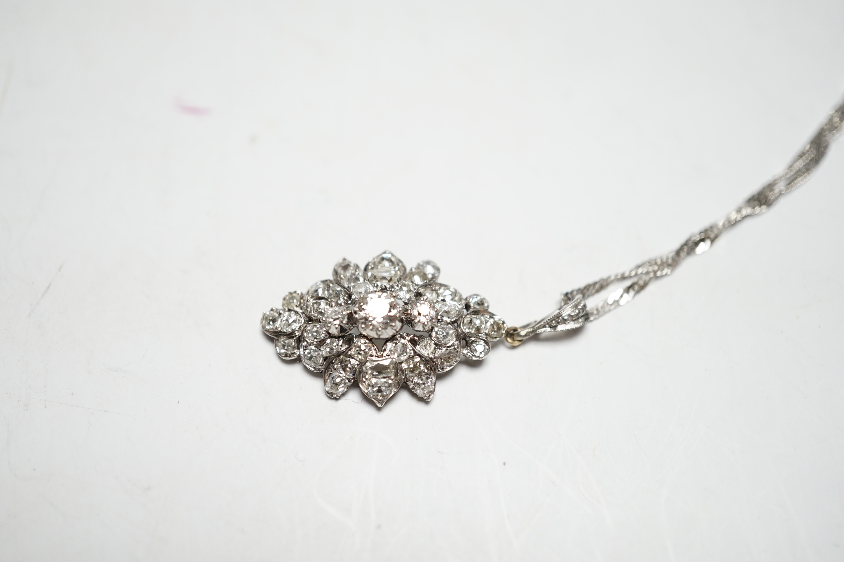 A white metal and diamond cluster set lozenge shape pendant, overall 38mm, on a modern 9ct white gold, chain, 45cm, gross weight 5.8 grams.